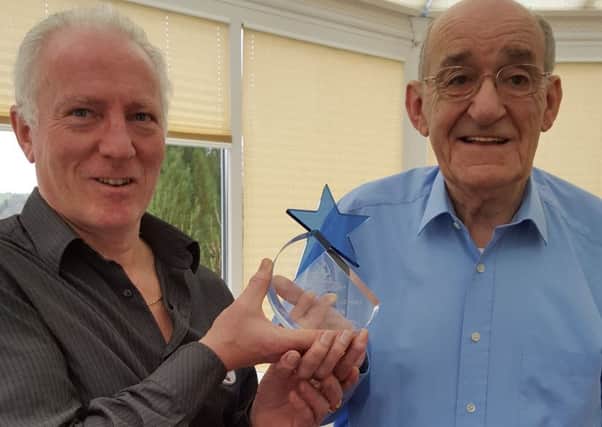 Ian Woolley from Quiz Britain presents Jim Bowen with an award for being Britain's favourite quiz show host.