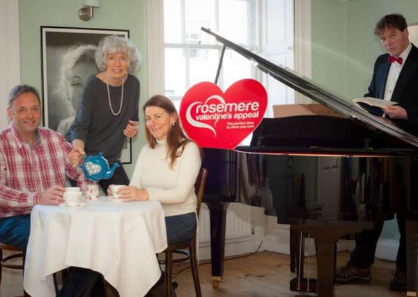 Marion Plowright, serves tea to guests at the pop up cafe with Stuart Wickes pianist.