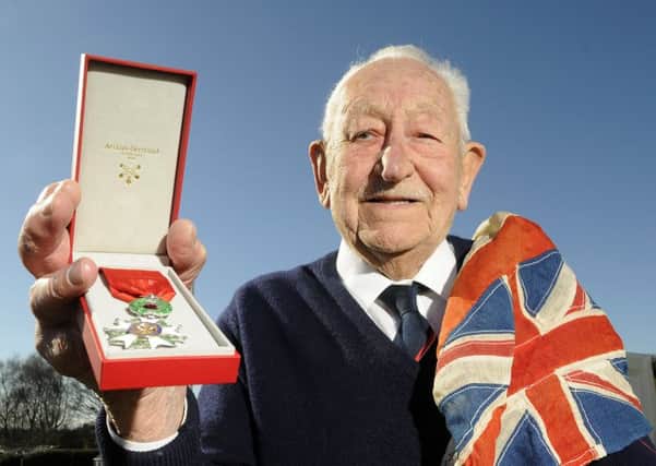 Veteran Reg Menzies with his Legion d'Honneur medal and the flag which flew on the ship he was on during the D-Day landings.