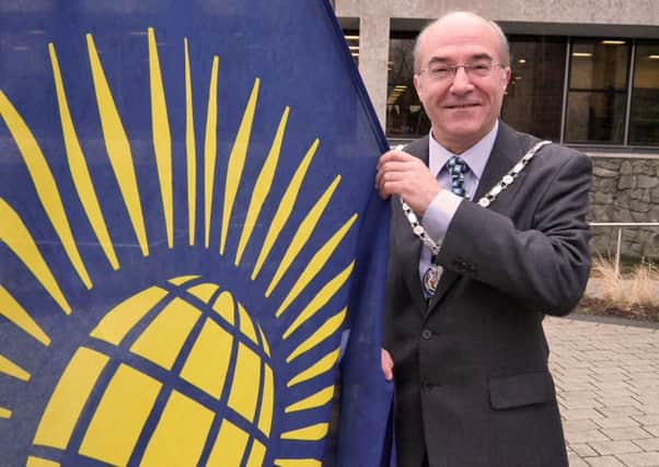 County Councillor Kevin Ellard, Chairman of Lancashire County Council raising the flag at County Hall to mark the international celebration of Commonwealth Day.