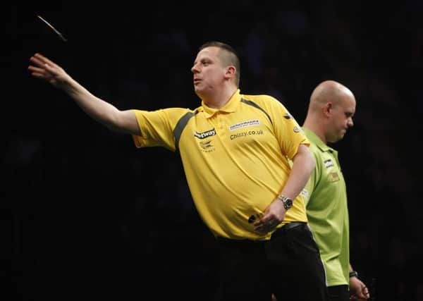 Dave Chisnall in action against Michael van Gerwin. Picture: Lawrence Lustig.