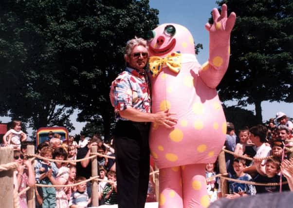 Noel Edmonds gives his creation 'Mr Blobby' a hug during the opening of Crinkley Bottom at Happy Mount Park in Morecambe in 1994.