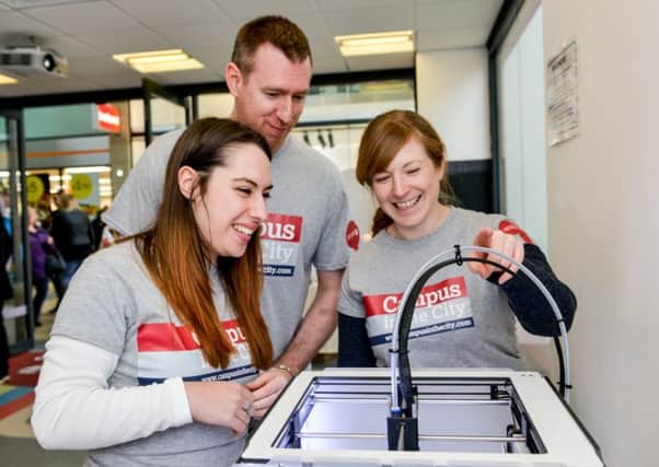 The Campus in the City team (from left) Eleanor Knowles, Joe Buglass and Lindsey King get to grips with the 3D printer.