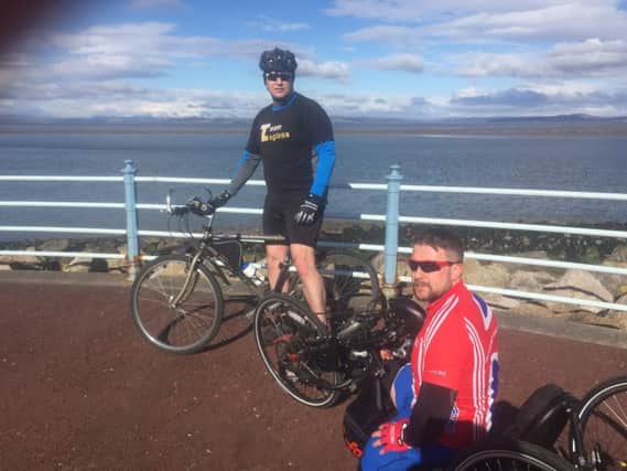 Stuart Robinson (in the forefront) and Kurt McGuinness undergoing training for their TT handcycle bid.