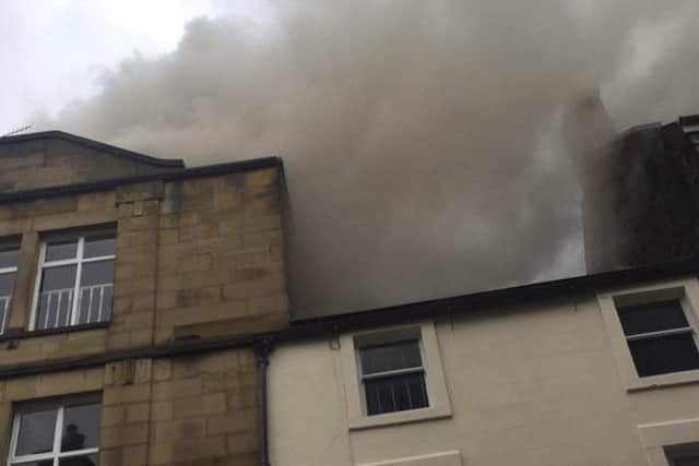 Smoke billowing above the Thornton's chocolate shop on Penny Street in Lancaster on Thursday morning. Photo by Adam Greenwood.