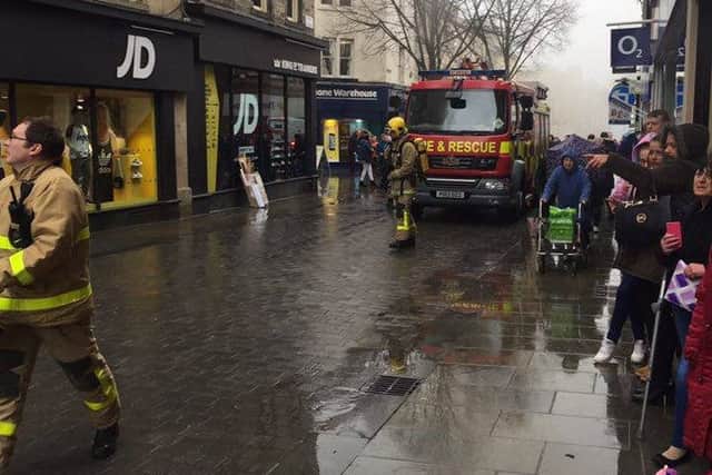 Fire crews arriving on Penny Street in Lancaster on Thursday morning as shoppers look on.