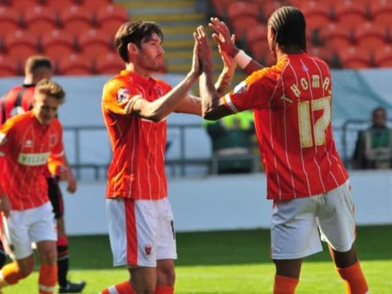 Connor Oliver, left, celebrates a goal for Blackpool's reserves against Morecambe earlier in the season.