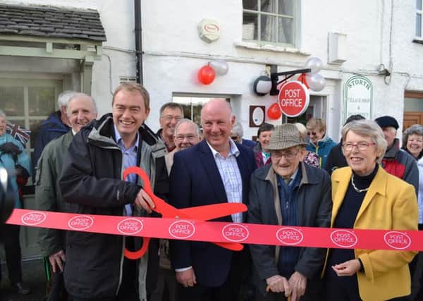 South Lakeland MP Tim Farron (left) cuts the ribbon at the official launch of Storth Community Cooperative Post Office which will be staffed entirely by volunteers, with former postmaster Rob Crompton and oldest customer Bill Matthews, aged 98.