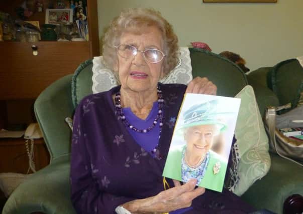 Margaret Baldwin celebrated her 100th birthday this week at a surprise party in Caton, here she is holding a congratulatory card from the Queen.