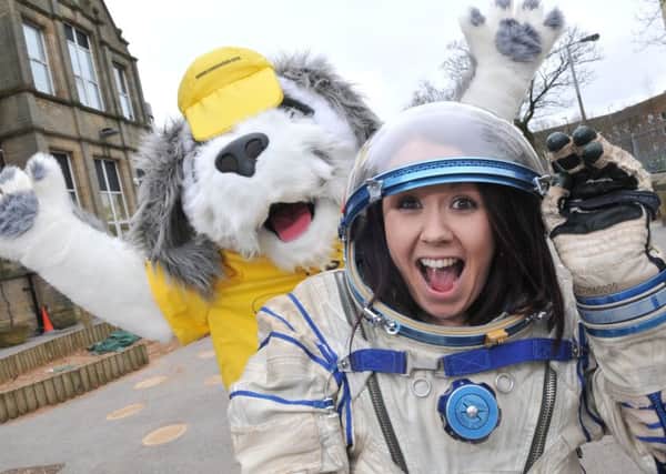 Photo Neil Cross: Teaching Assistant Carol Bonehill in the space suit at Morecambe Bay Primary School, with 'Sam the Dog', the Morecambe Midland Hotels lucky dog mascot, before blasting a smaller version of Sam into orbit.