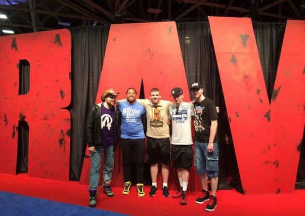 Kieran Engelke (left) with friends Liam Jackson, Ryan Hunter, Will Soper and Bryan Fulton posing with the 'Monday Night Raw' sign in Dallas at WrestleMania weekend.