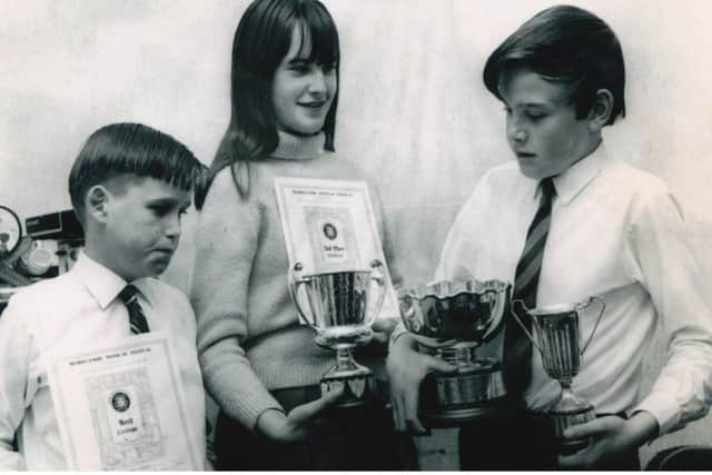 Linda with her brothers Nigel and Steven with trophies from the Morecambe Music Festival.