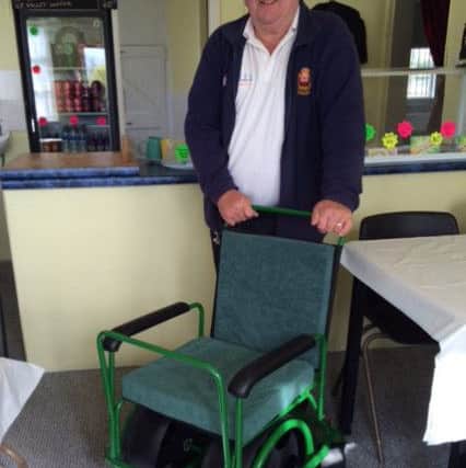 Brian Cooke with one of the green friendly wheelchairs.
