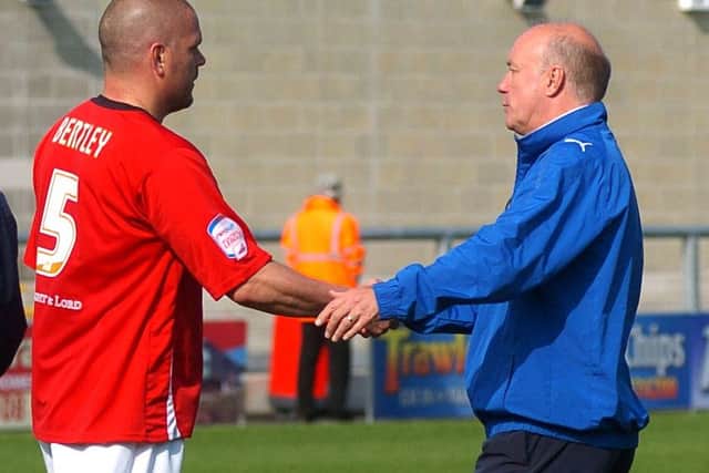Jim Bentley shakes hands with Sammy McIlroy at the end of what turned out to be the Northern Irishman's final game in charge of Morecambe. Picture: Garth Hamer