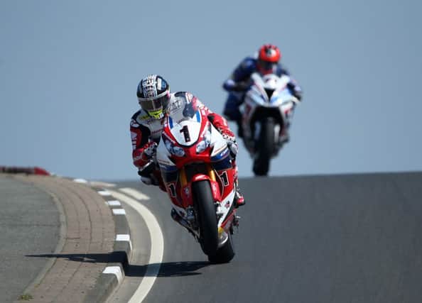 John McGuinness is action during superbike qualifying at the North West 200.