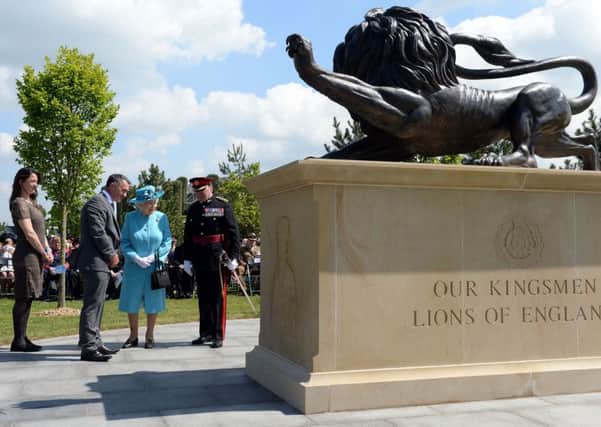 Queen Elizabeth II views the new Duke of Lancaster's Regimental memorial during a service at the National Memorial Arboretum in Alrewas, Staffordshire. Photo: Joe Giddens/PA Wire