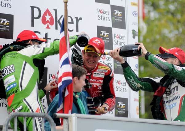 John McGuinness celebrates after winning the Senior TT in 2015.