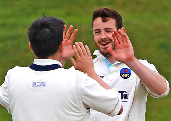 Ben Simm congratulates Liam Moffat on a wicket against Darwen. Picture: Tony North