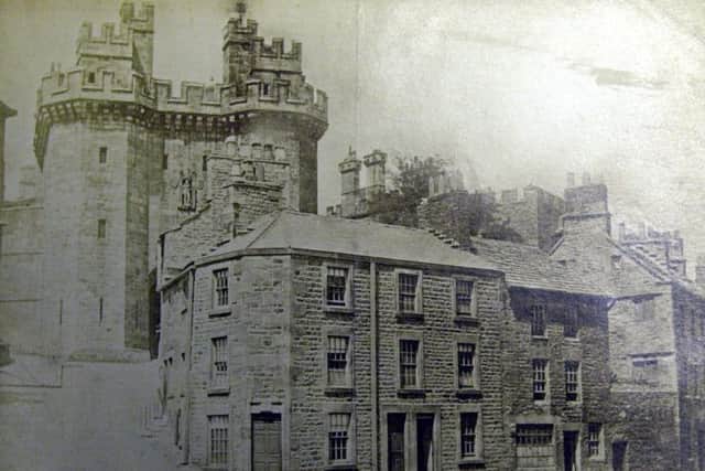 A view of Lancaster Castle which will never be seen again with houses nestling right up the the gateway in 1875. 2604022 - 4