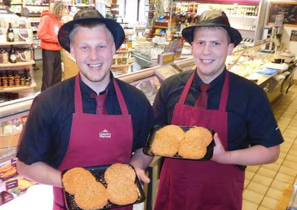Kabel Taylor (left) and brother George Taylor with the award-winning Cajun Chicken Burgers at Country Harvest, Ingleton.