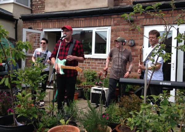 Kriss Foster (lead vocals) and The Thyme Machine play a gig in fan Darren       's garden.