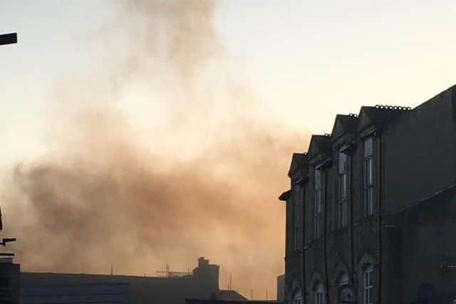 The flames erupting from the roof of the Poundland store. Picture by Lucy Benson.