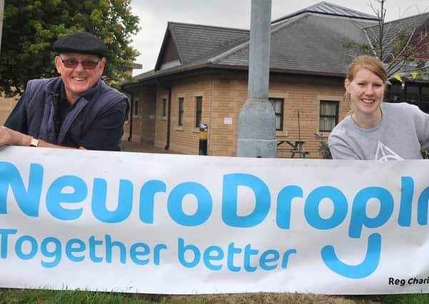 Feature on the Neuro Drop-In Centre at Lancaster Farms. Volunteers Brian Moorcroft and Eleanor Dawson fix a new sign outside the centre.