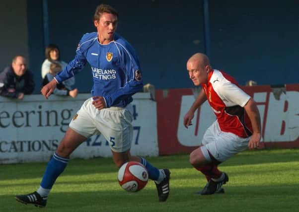 Michael Stringfellow takes the ball away from Morecambe's Wayne Curtis during the last meeting between the sides back in 2009.