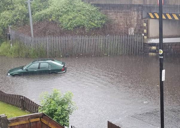 A car being swept away on Torrisholme Road, Lancaster. Picture by Mark Richardson.