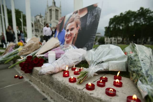 Flowers and candles at Parliament Square opposite the Palace of Westminster, central London, left in tribute to Labour MP Jo Cox, who died after being shot and stabbed in the street outside her constituency advice surgery in Birstall, West Yorkshire. PRESS ASSOCIATION Photo. Picture date: Thursday June 16, 2016. The alleged gunman has been named locally as Tommy Mair, 52, who neighbours in Birstall have described as "a loner". See PA story POLICE MP. Photo credit should read: Yui Mok/PA Wire