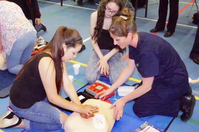 Pupils learning how to resuscitate.