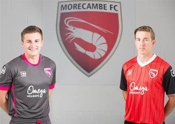 Aaron McGowan and Andy Fleming show off Morecambe's new kits for the 2016-2017 season.