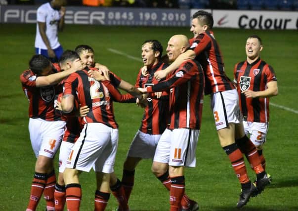 Morecambe celebrate Shaun Miller's goal in their win at Bury in last season's Johnstone's Paint Trophy second round.