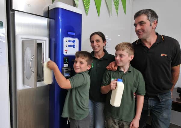 Photo Neil Cross
Amy and James Burrow with their children Eddie and Ollie and their raw milk vending machine in Silverdale