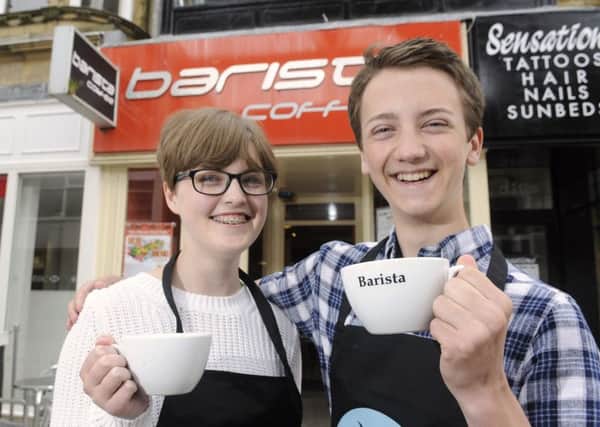 Youngsters from the National Citizen Service set up a scheme to allow people to buy a pending coffee for the homeless at several cafes. Pictured are Brittany Morley and Luke Munday.