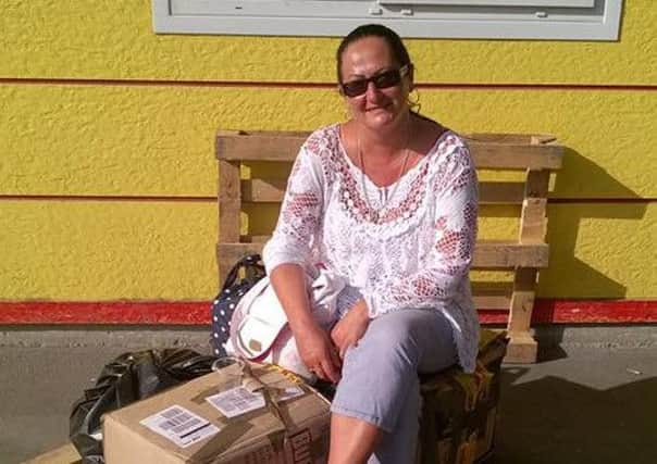 Sylwia Borowska with the package of children's clothes she donated to refugees.