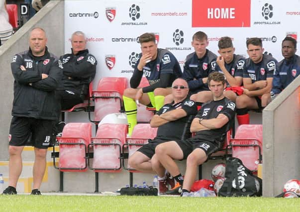 Morecambe boss Jim Bentley and his staff look on during the mini-tournament.