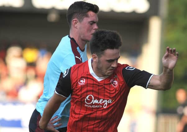 Goal scorer Rhys Turner battles with Michael Keane at the Globe Arena on Tuesday night. Picture: Rob Lock