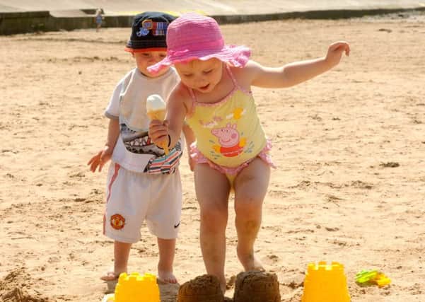 Ruby Wilson and Dylan Allen from Lancaster have fun in the sun at South Bay beach in Heysham.