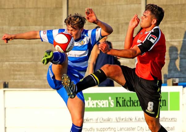 Charlie Russell challenges Ben Hedley in Lancaster City's win over Morecambe. Picture: Tony North