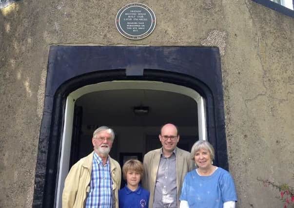 From left, Hugh Roberts, Oliver Brigham, 10, Martin Brigham, and Elizabeth Roberts outside the Friends Meeting House in Lancaster.