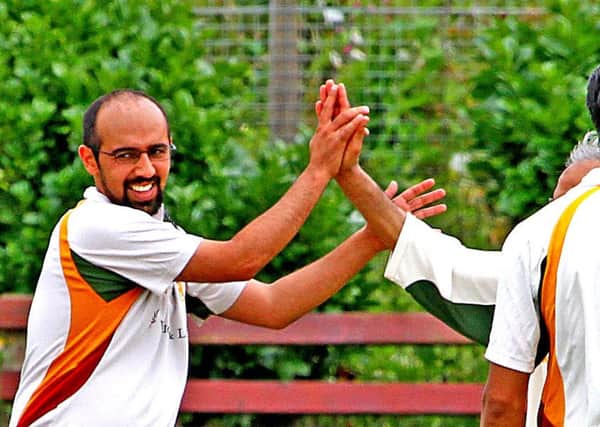 Uzair Shah, left, celebrates one of his three wickets. Picture: Tony North