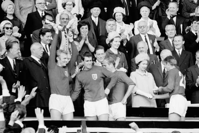 England Captain Bobby Moore holds aloft the Jules Rimet Trophy, followed by hat-trick hero Geoff Hurst, Bobby Charlton and Roger Hunt