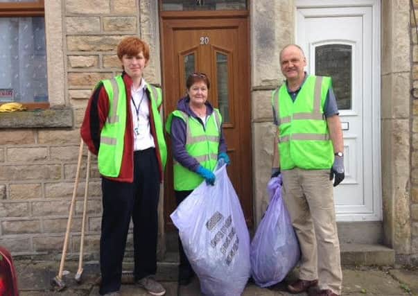 Coun Oscar Thynne (left) with residents taking part in the street cleaning session in Havelock Street.