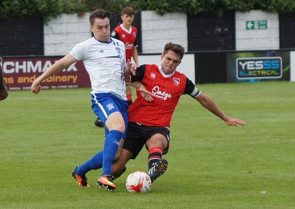 Ben Hedley battles for the ball against Bury.