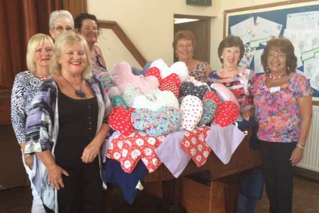 Members of Bare and District WI with the angel pillows. Tricia Heath (second from left)from 13 The Warehouse  donated materials such as ribbons, materials and stuffing for the angel pillows which were made by members of the WI.