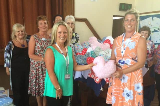From left: Tricia Heath from 13 The Warehouse, Janet Hemingway from Bare and District WI, June Baker,and front left: Andrea Partridge, volunteer and engagement co-ordinator from CancerCare, with volunteer Sarah Drake receiving the pillows which are distributed in hospitals.