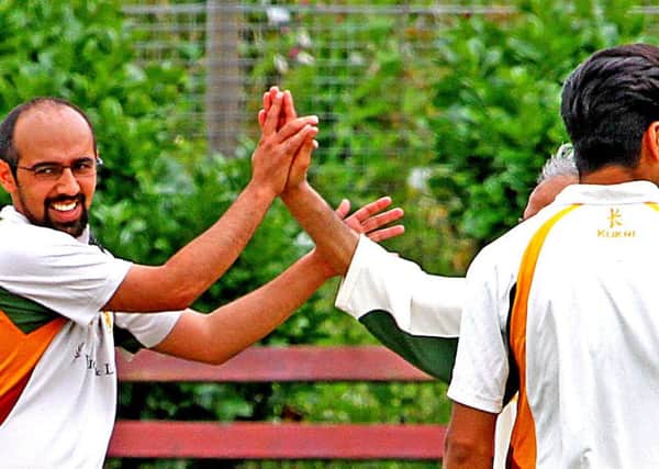 Uzair Shah (left) celebrates his wicket.