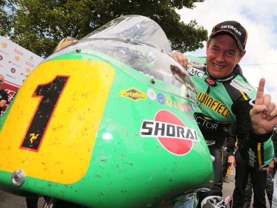 John McGuinness celebrates another victory on the Isle of Man on Saturday.