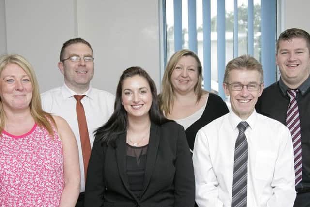 Members of the Johnsons Apparelmaster Service and Management Team. From left are Linda Clark (customer service administrator), Richard Dagger (customer service administrator), Danielle Mercer (customer service manager), Sally Reade (office manager), Graham Huddleston (general manager) and James Barker (customer service administrator).